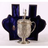 Victorian silver lidded cup with relief vignettes and figure finial with inscription ' Barry