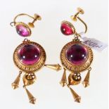 Pair of Unhallmarked yellow metal earrings set with pink cabochon stones, the screws stamped 9ct, 9.