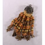 Small Benin bronze or brass mask with grass head and long beaded tassels with animal terminals,