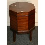 George III mahogany octagonal cellerette with twin brass handles, the base raised on brass castors,