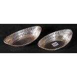 Pair of silver sweetmeat dishes of navette shape, pierced and embossed, by Hamilton & Inches,