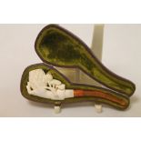 Late 19th century Meerschaum carved "Pine Cone in Hand" pipe with amber stem, as new, 10cm long,