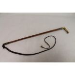 Victorian or Edwardian huntsman's whip with horn handle, white metal ferrule decorated with hounds,