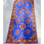 Modern Eastern style wool runner with medallions on blue field. 178cm x 86cm.