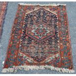 Persian rug, the central medallion over blue ground, geometric floral design,