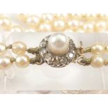 Two row necklace of graduated pearls with diamond and pearl snap (No certificate).