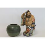 Oriental porcelain figure of Hotei with small child at foot,