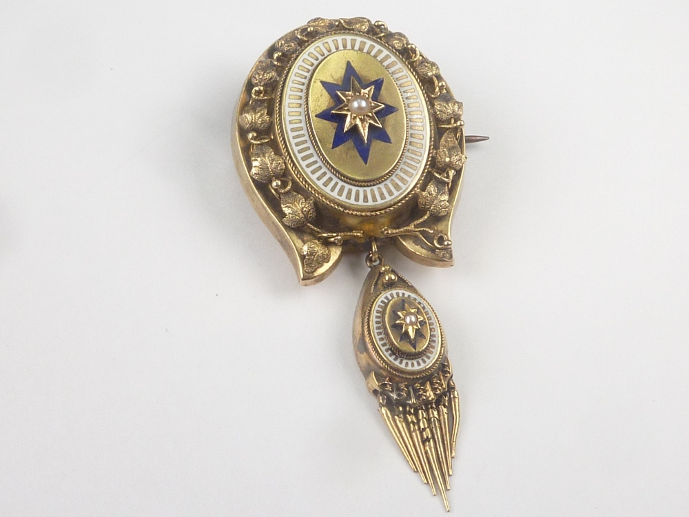 Victorian gold pendant of horse shoe shape with enamel and pearl, with tassel.