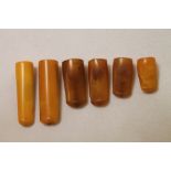 Six late 19th century amber cigar holders, the largest 5cm long. (6).