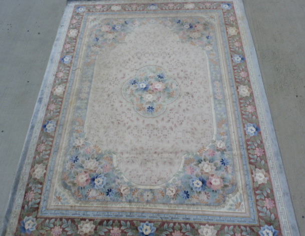 Large Chinese silk floral carpet in pale pastel colours. 370cm x 275cm.