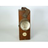 Vintage battery powered hand lamp with early globular bulb in mahogany case marked for Lithanode