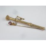 Victorian gold engraved pencil by Mordan and a garnet set stick pin in gold claw.