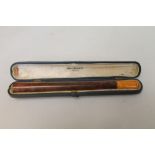 Alfred Dunhill Ltd. London briar-wood cigarette holder with amber mouthpiece, 15cm long, cased.