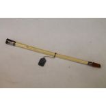 Early 20th century Albatross bone cigarette holder with silver mounts and amber mouthpiece,