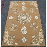 Chinese rug, the central medallion over brown ground, spandrels woven in scrolls. 150cm x 92cm.