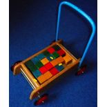 Set of child's wooden building blocks and trolley.