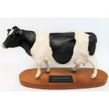 Beswick figure: Friesian Cow - On wooden plinth, no. A2607, black and white satin matt, 19cm high.