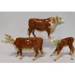 Three Beswick figures: Hereford Bull, no. 949, 14.6cm high; Hereford Cow, 2nd version, no. 948, 12.