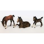 Three Beswick figures: Foal (Lying), no. 915, brown gloss, (chipped ear), 8.