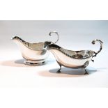 Silver cream boat with gadrooned edge on pad feet, and another on oval foot,