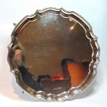 Silver circular tray with shaped moulded edge on pad feet, 30cm, 22oz.