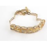 Gold bracelet with graduated citrines '14k'. Condition Report. 12.8g gross.