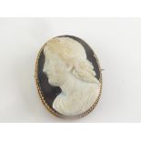 19th century onyx cameo brooch with a classical head in high relief on corded gold '15ct'.