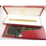 Must de Cartier rolled gold ball point pen, with case and details.