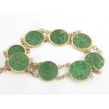 Chinese gold bracelet with eight carved jade discs, character mark, 14k.