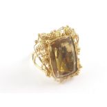 Gold filigree ring with foiled citrine the band '18ct'.