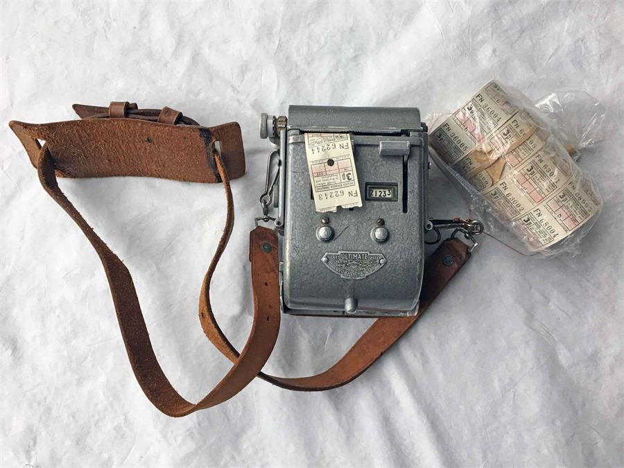 An Ultimate 2-roll TICKET MACHINE complete with original leather strap and 4 unused ticket rolls