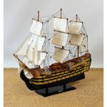 A wooden model of HMS Victory, on stand, 71cm high CONDITION REPORT: Lightly grubby,