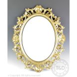 A Florentine style carved gilt wood and gesso oval wall mirror,