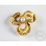 An 18ct gold trefoil shaped brooch, import mark for Birmingham 1966,