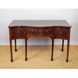 A George III style mahogany serpentine sideboard, with three drawers, on tapered legs,