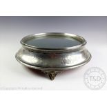 A large circular silver plated mirror top cake stand, with bright cut scroll decoration,
