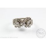 A diamond set double cluster ring,