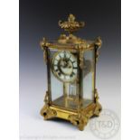 A late 19th century American brass four glass mantel clock,
