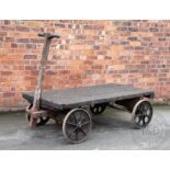 A late 19th century cast iron and pine railway station luggage wagon / pull along trailer,