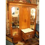 An Edwardian inlaid satinwood wardrobe, with a panelled and a mirrored door, above two drawers,
