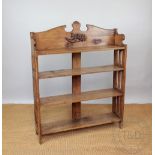 A Victorian pine dwarf open bookcase, with four shelves and pierced sides, 125cm H x 100cm W x 25.