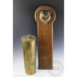 An early 20th century novelty dinner gong, the oak back plate moulded with a brass bull dog head,