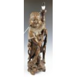 An early 20th century Japanese carved hardwood figural table lamp,
