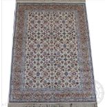 An ivory ground Kashmir carpet, worked with an all over floral design against an ivory ground,