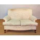An early 20th century two seater settee and matching arm chair in Howard & Son style,