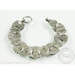 A Victorian silver bracelet, designed as alternating panels of engraved silver links,