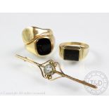 A collection of three signet rings, comprising; an onyx set 9ct gold example,