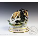 A German porcelain group depicting a boar hunt, modelled with a wild boar and hound battling,