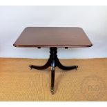 An early 19th century mahogany tilt top table,