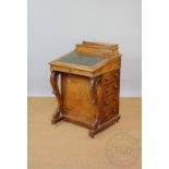 A Victorian carved walnut Davenport, with hinged stationery box and slope above four side drawers,